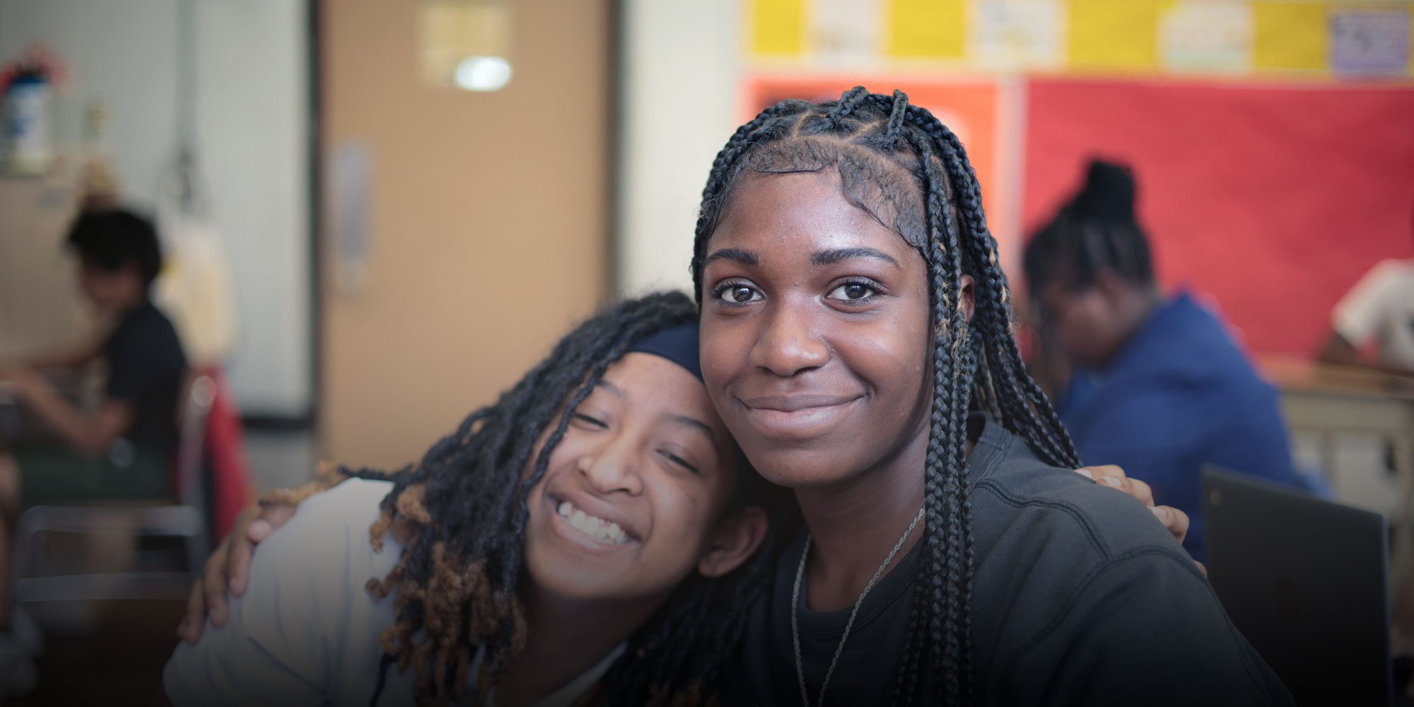 Smiling students in a classroom
