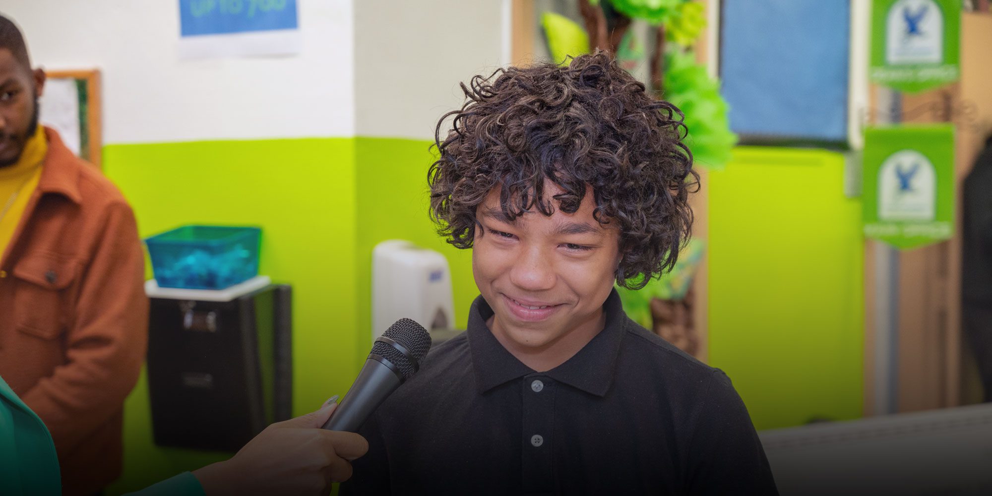 Middle school student speaking into a microphone